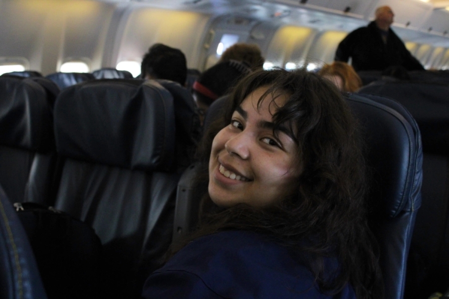Girl smiling while looking behind.