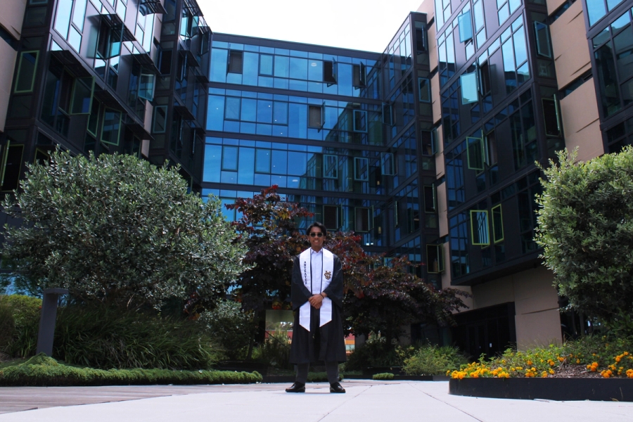 Boy posing in the middle of dorms.