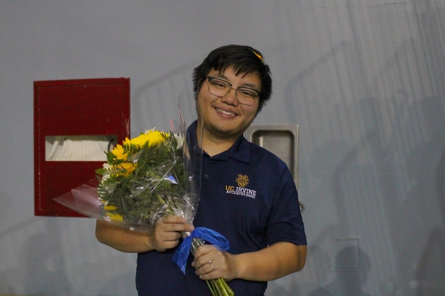 Boy holding bouquet of flowers.