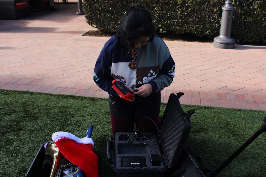 Girl putting battteries in device.
