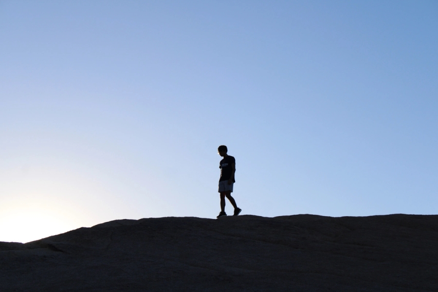 Filipino boy walking during sunset.