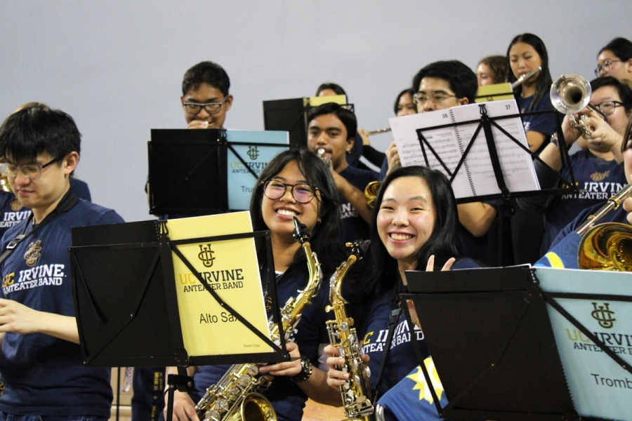 Two alto sax girls posing and smiling.