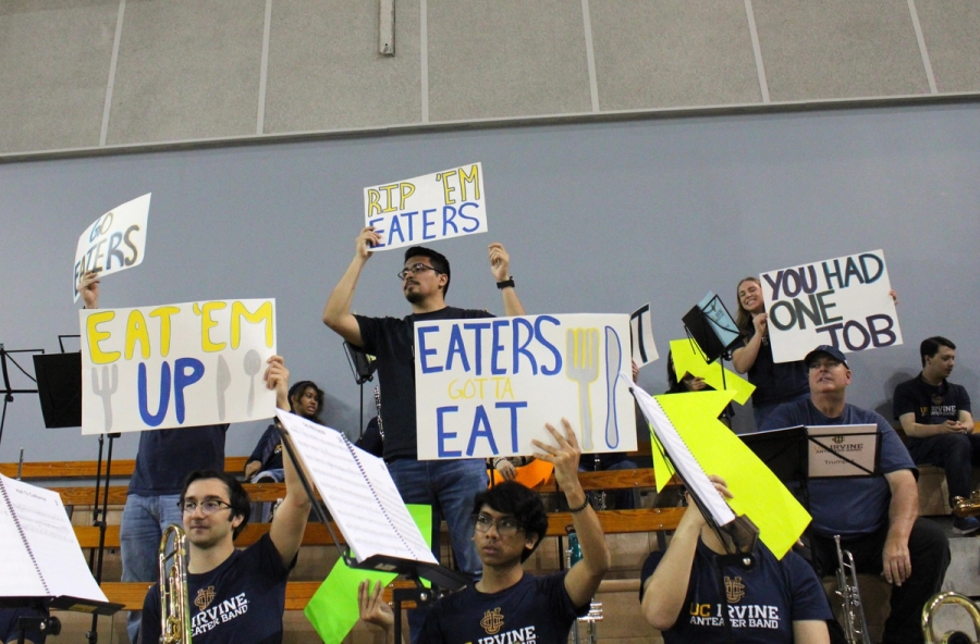 Band holding signs and arrows.