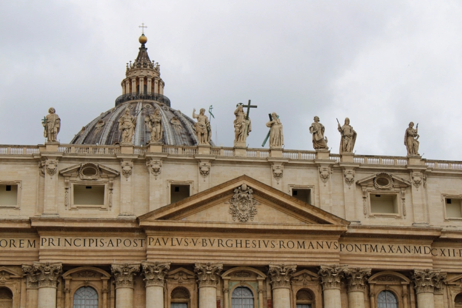 Top dome of building with statues.