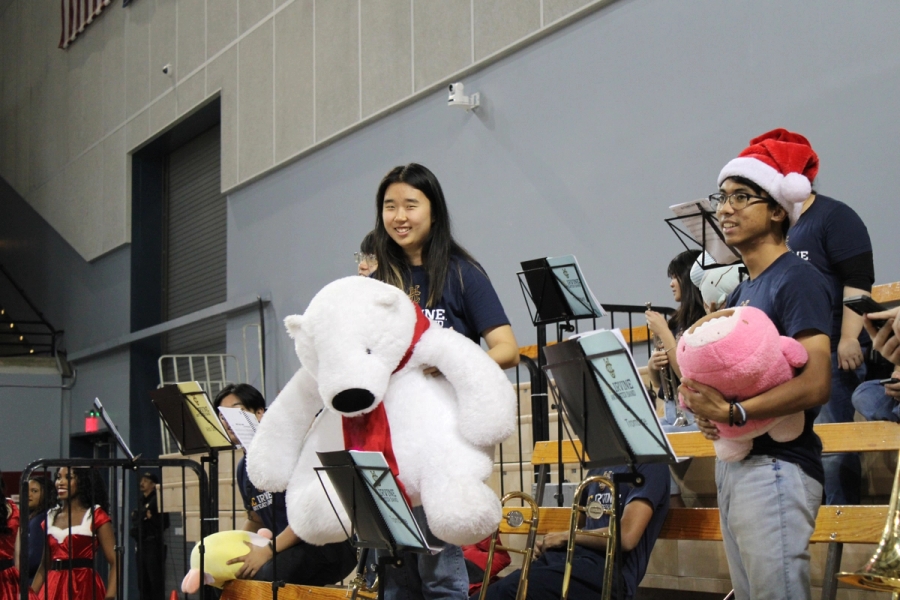 Girl holding huge white stuffed polar bear.