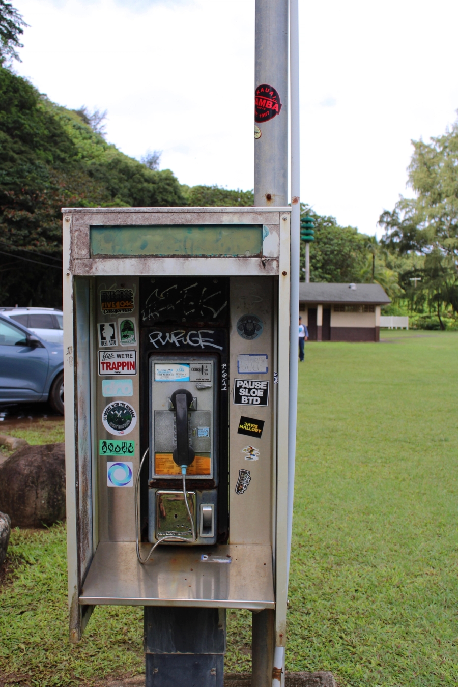 Old phonebooth with stickers.