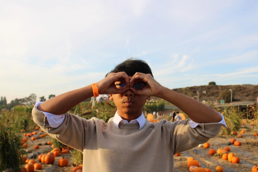 Boy making hand goggles.