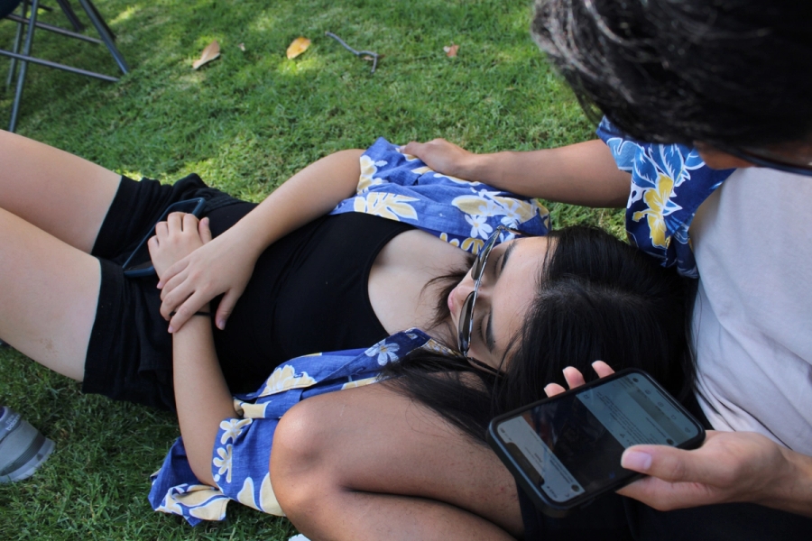 Girl laying on guy's leg.