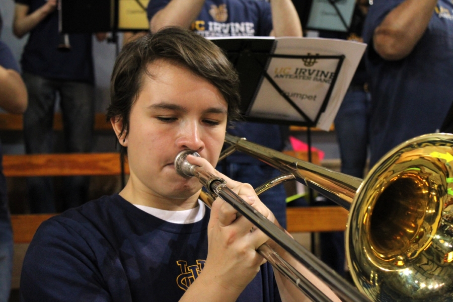 Front POV of boy playing trombone.