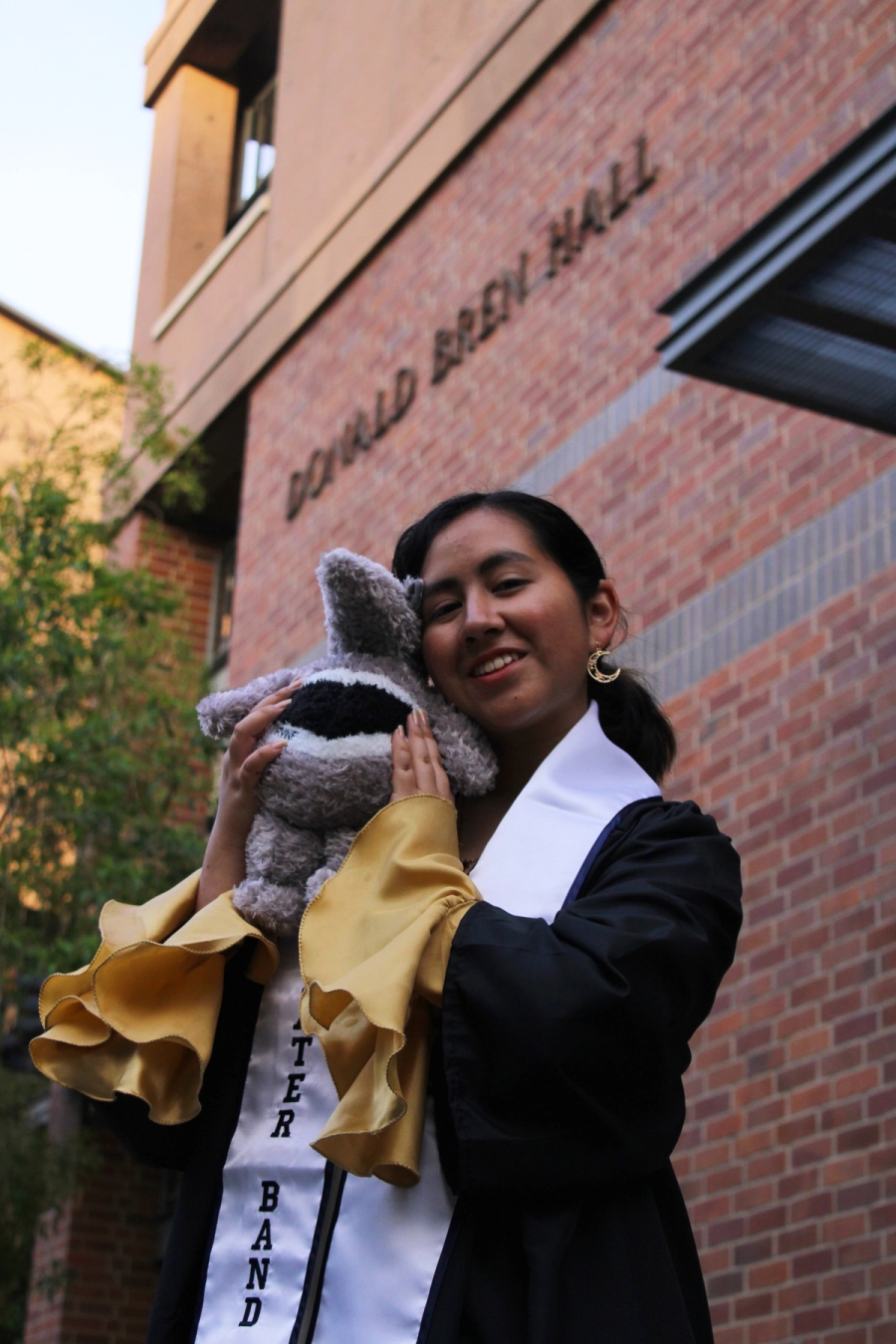 Girl posing with anteater plush.