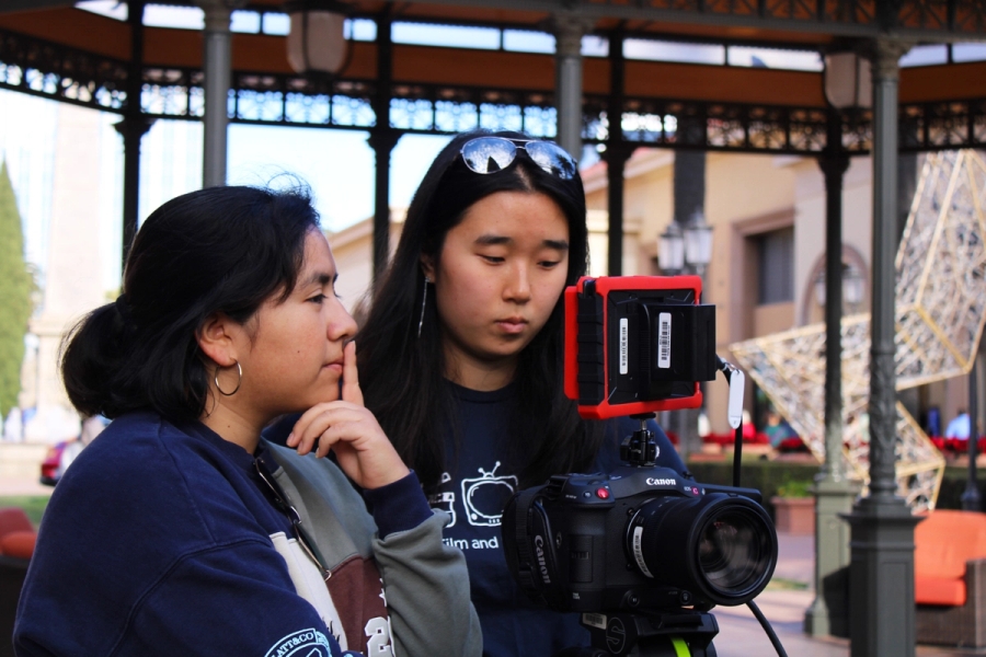 Two girls looking at the monitor.