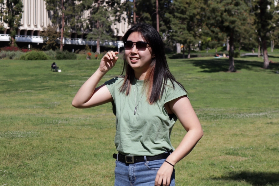 Girl adjusting shades.