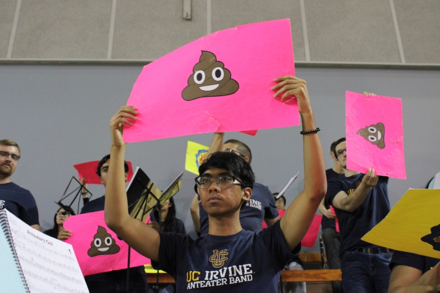 Boy holding a poop emoji.