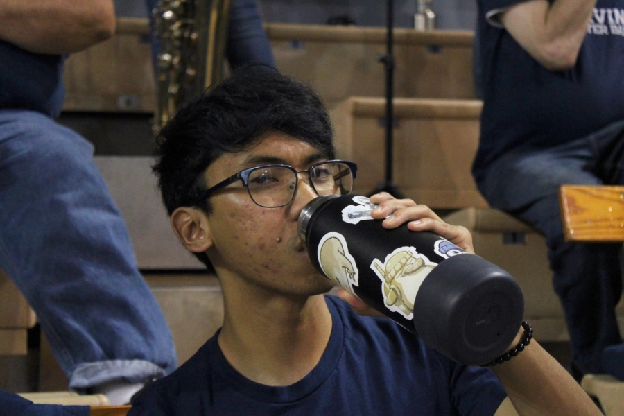 Boy looking at camera while drinking water.