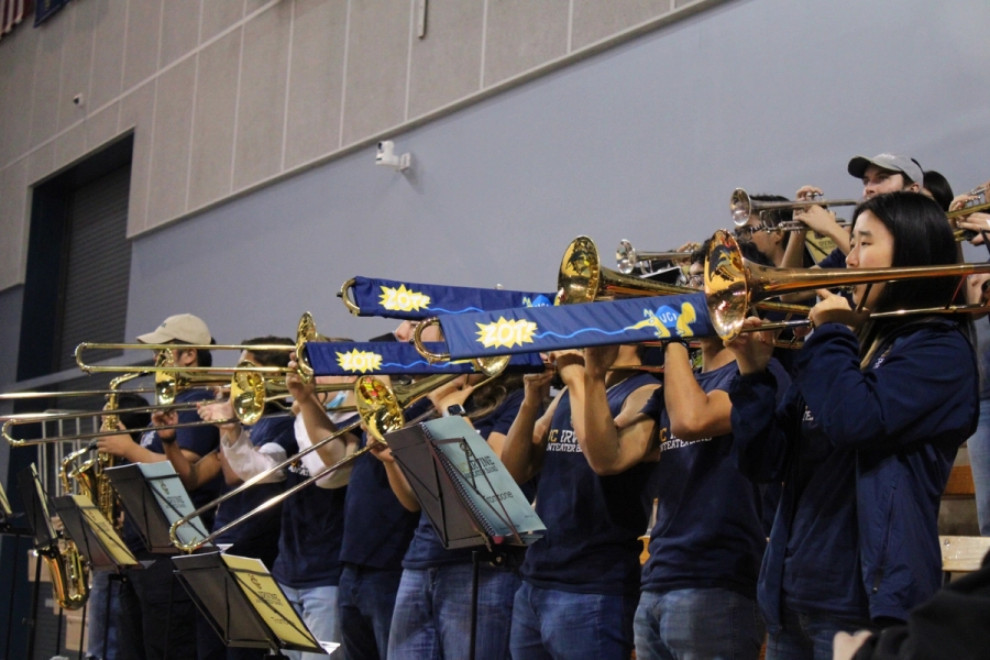 Side POV of trombones playing with slide covers.