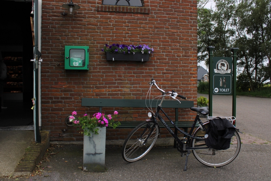 Bike in front of brick building.