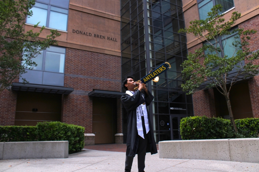 Boy playing trombone in grad fit.