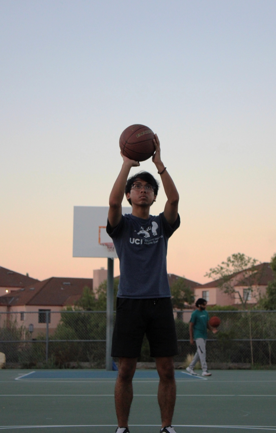 Boy shooting basketball.