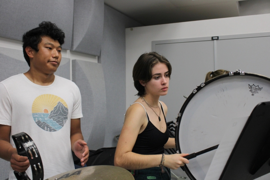 Boy on tambourine and girl on bass drum.