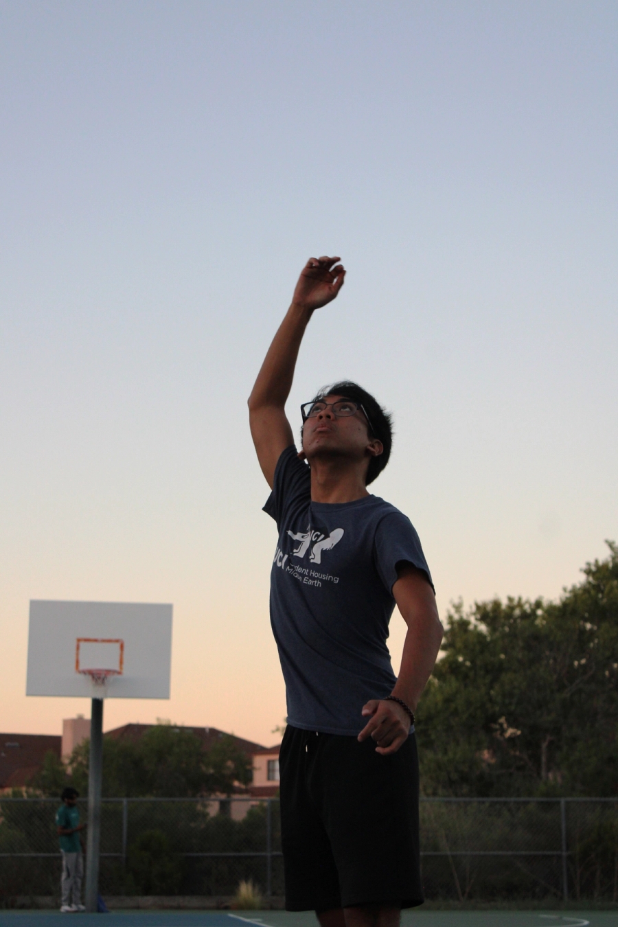 Boy finishing hook shot.