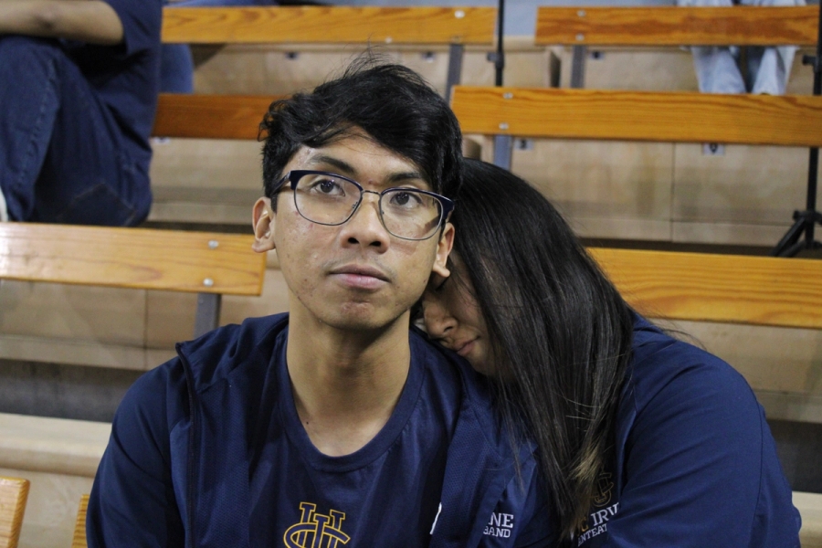 Girl napping on boy's shoulder.