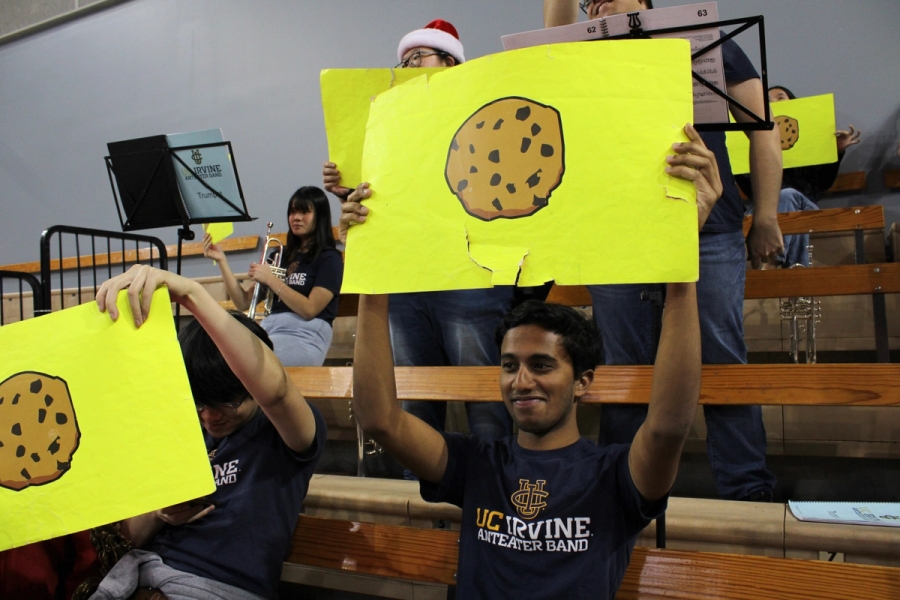 Boy holding cookie emoji.