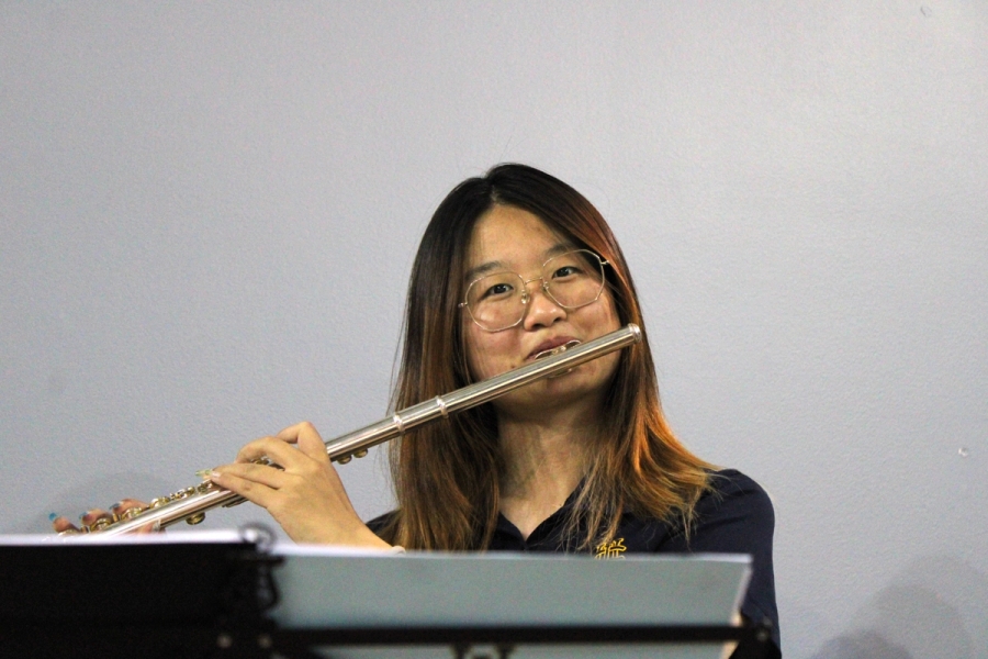 Front POV of girl playing flute.