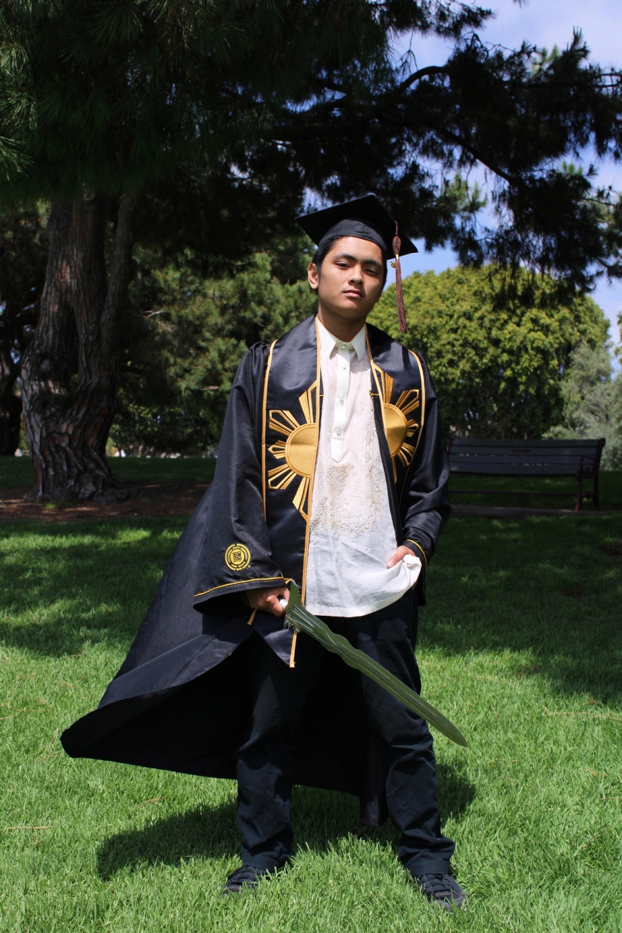 Man in Filipino grad fit with large sword 2.