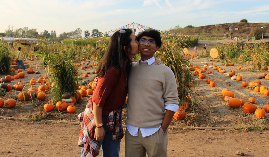 Girl kissing boy on cheek.