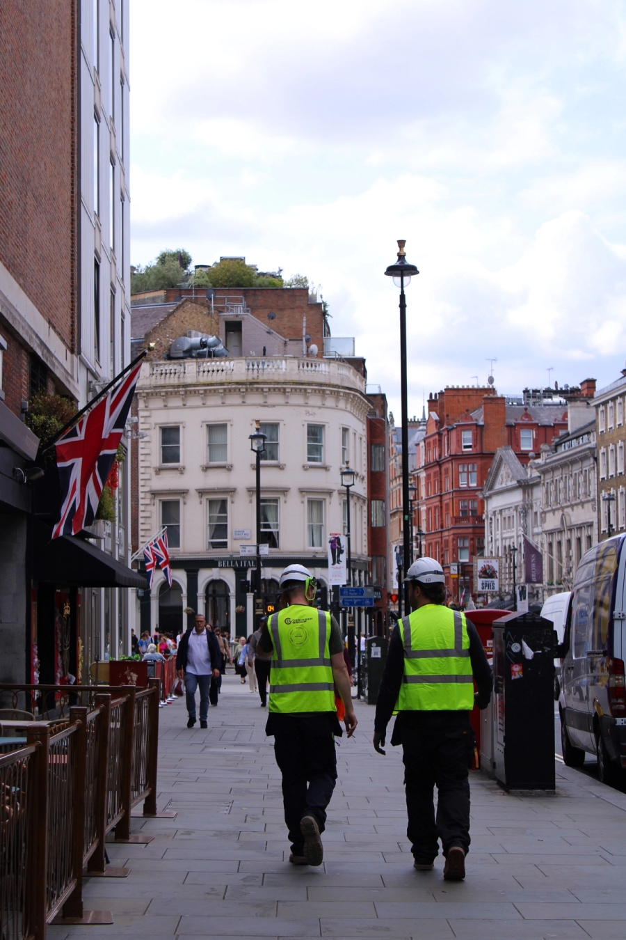 Two construction workers walking streets of London.