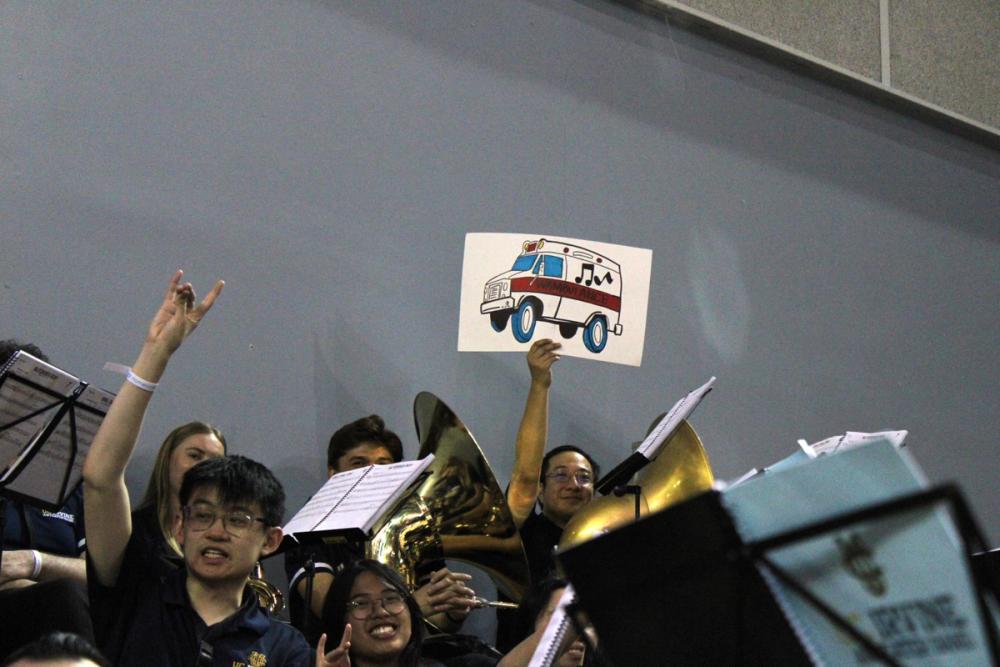 Man holding a "Wambulance" sign.