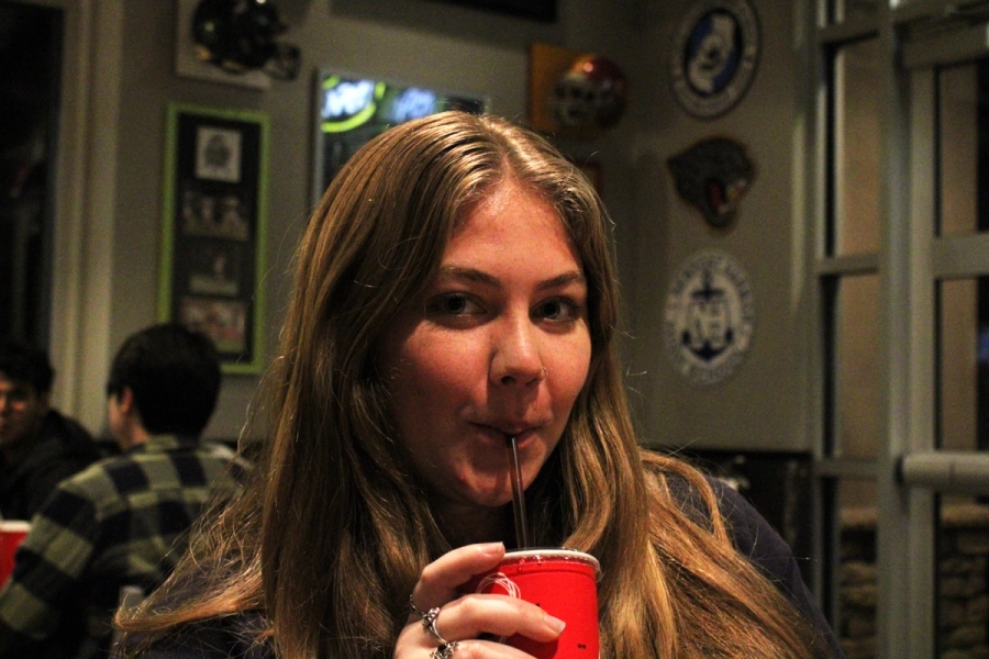 Girl sipping drink.