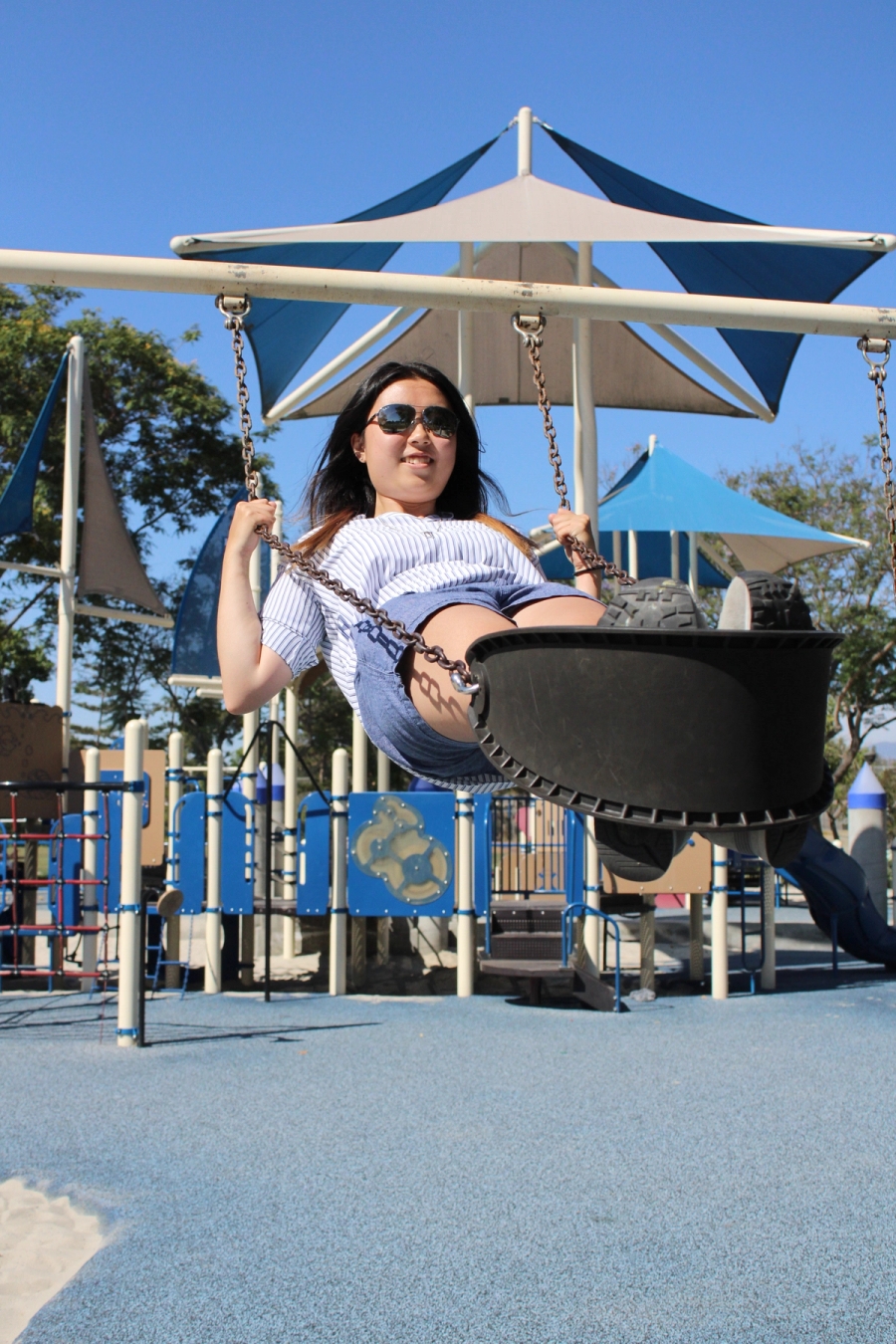 Girl almost horizontal on swing.