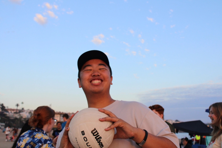 Boy holding volleyball.