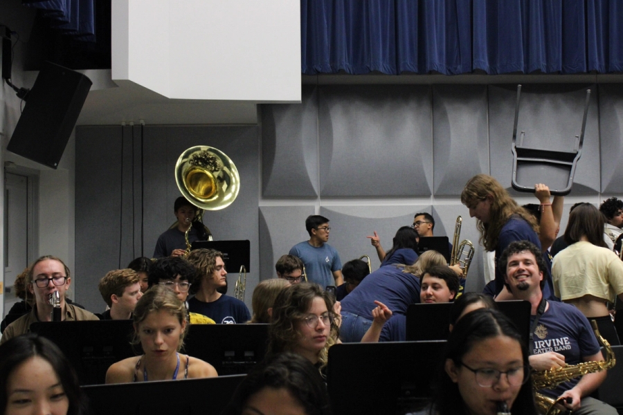 Students setting up in the back of the rehearsal room.