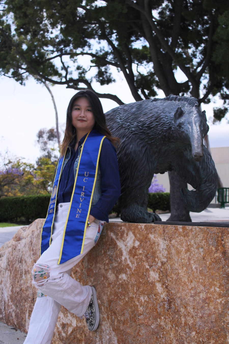 Girl posing in front of anteater statue.
