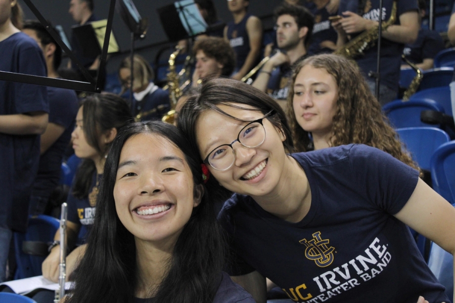 Two girls in the front smiling.