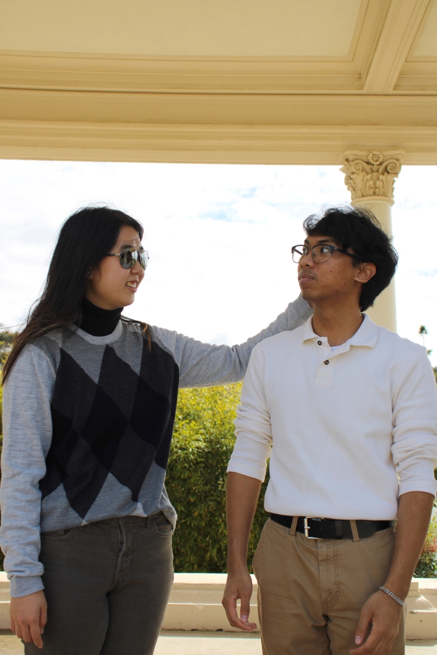 Girl touching boy's hair.