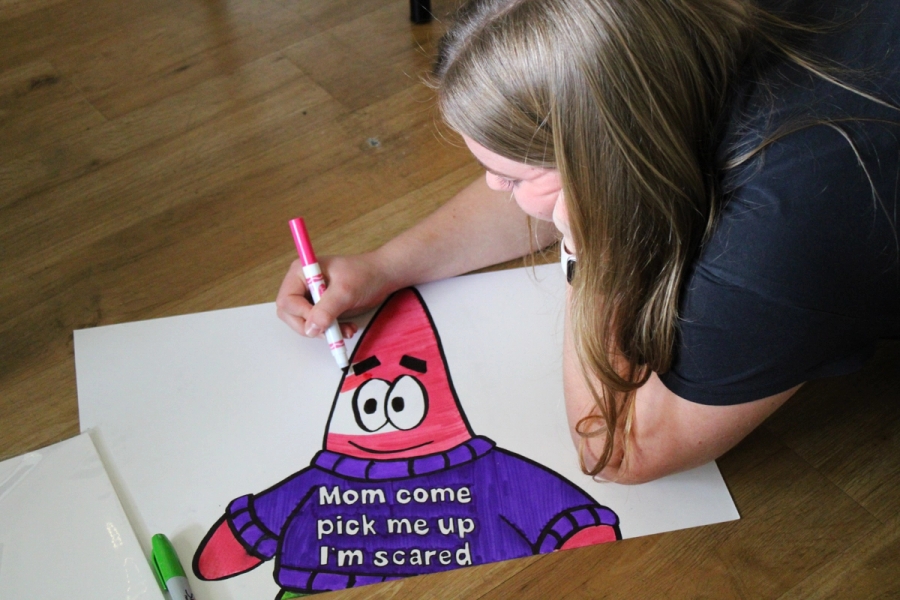 Girl coloring in Patrick.
