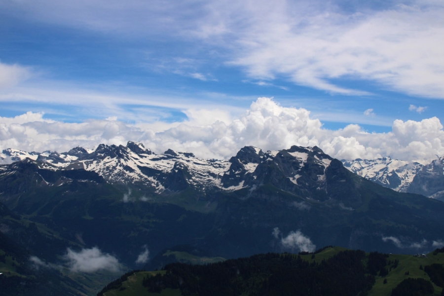 Clouds and snow-capped mountains.