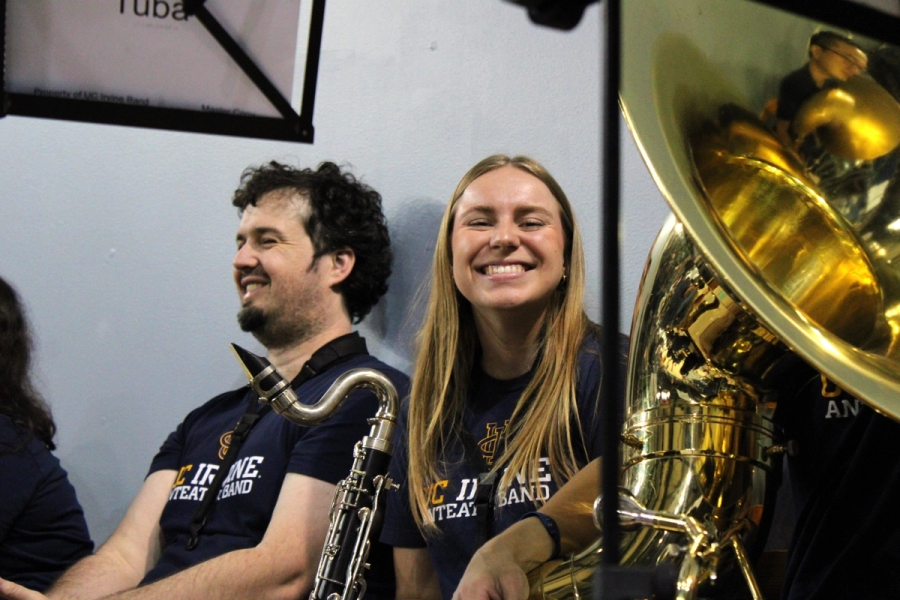 Girl smiling near tuba.