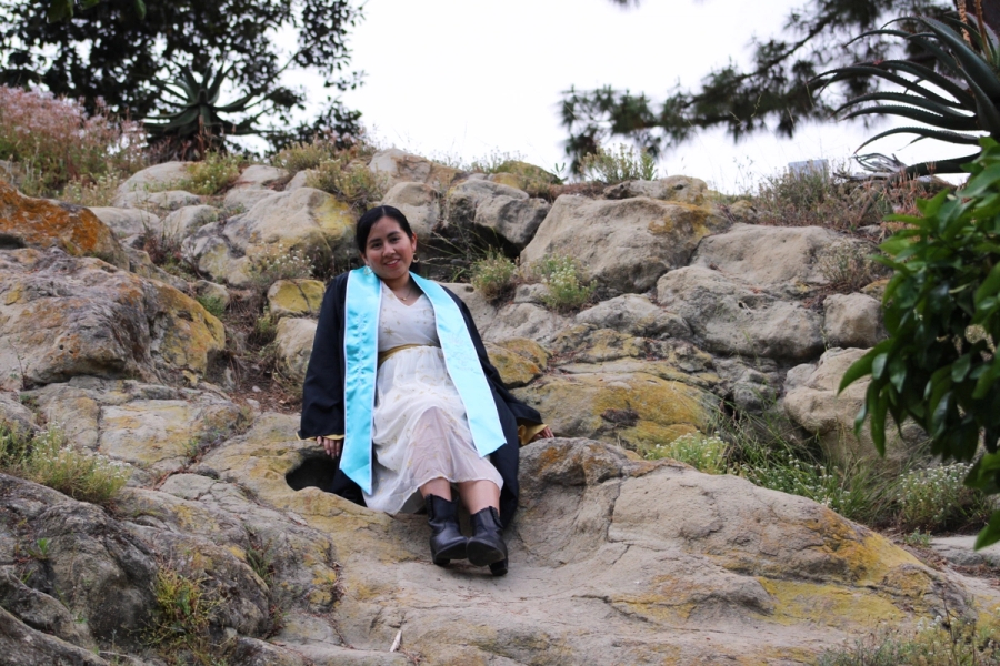 Girl sitting on rocks.