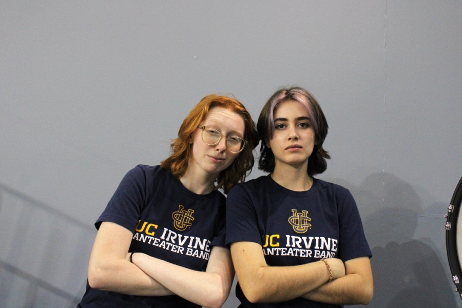 Two girls posing with crossed arms.