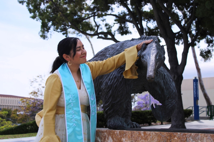 Girl petting anteater statue.