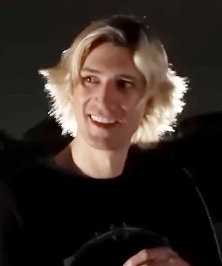 xQc (Félix Lengyel) smiling with his blond hair lit from behind, July 2023