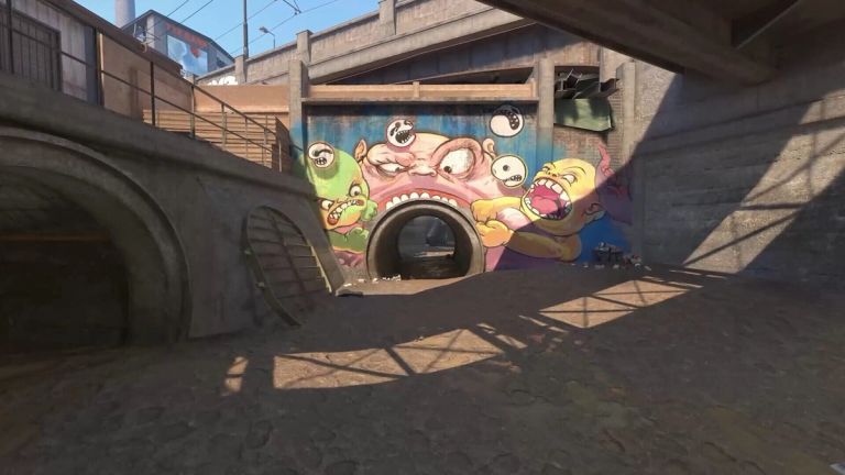 Counter-Strike 2: Monster graffiti above a round drainage tunnel in a concrete channel.