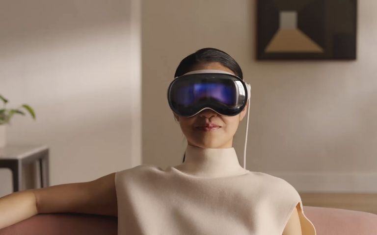 A woman wearing an Apple Pro Vision headset