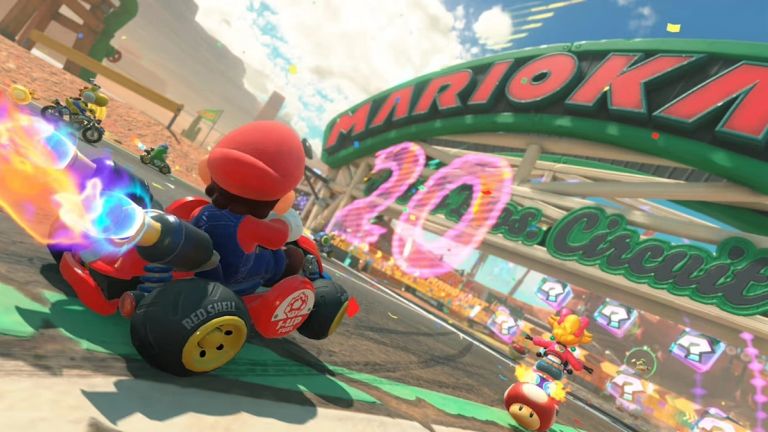 Mario Kart World: Mario races beneath a Mario Kart arch while other racers approach item boxes.