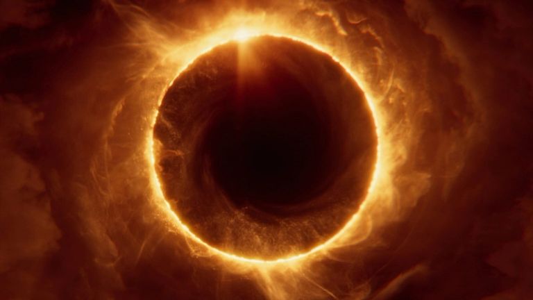 Saros: A dark circle surrounded by a glowing ring of fire and swirling orange clouds.