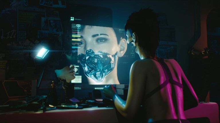 A woman watches a large digital image in a blue-lit room.